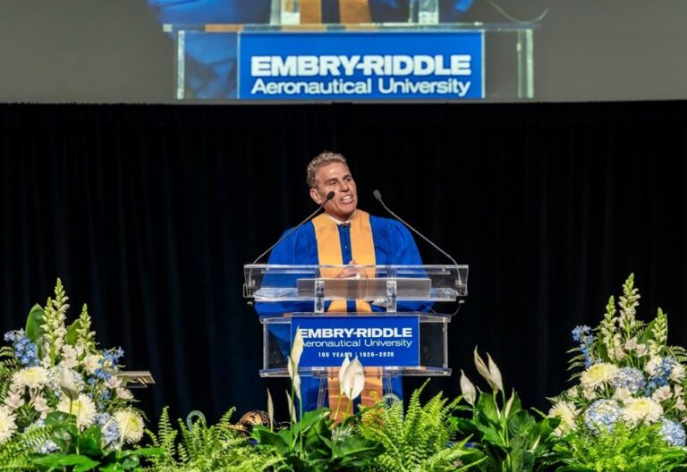 Kenn Ricci at the podium delivering a speech for the Embry Riddle commencement ceremony